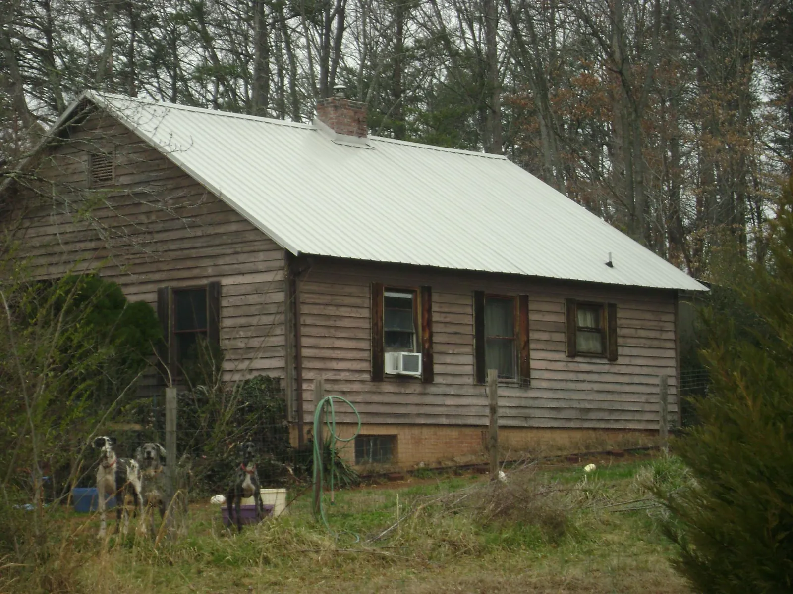 White metal roof on an old wood sided farmhouse, from a Metal Roof Installation job in Mill Neck